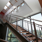 Ein Blick ins Innere offenbart eine moderne Holztreppe als architektonisches Highlight der Dachaufstockung, die Funktionalität und Ästhetik perfekt vereint. – SÄBU Holzbau